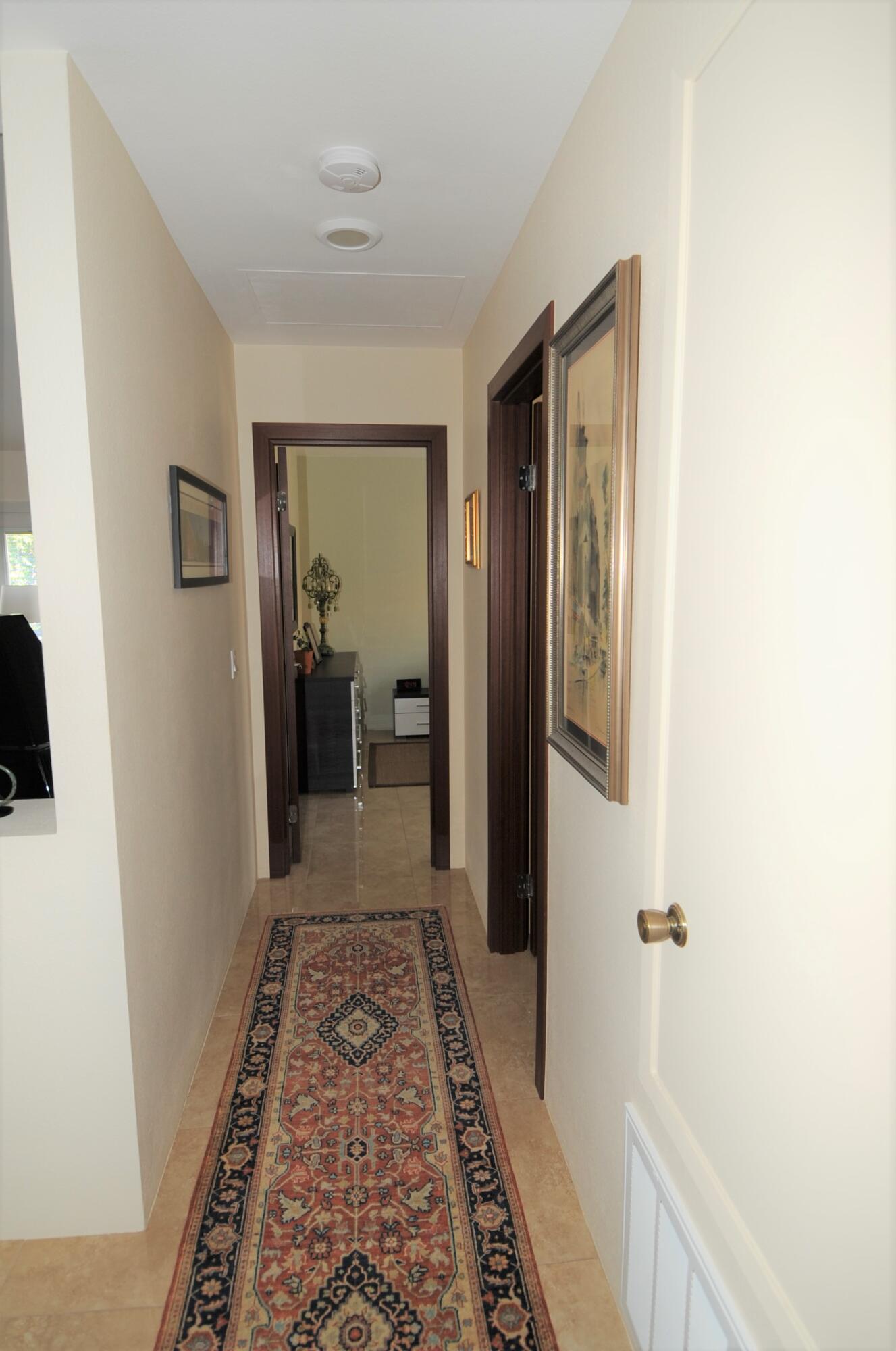 1490 East Racquet Club Road Palm Springs, CA 92262 - Photo 22 of 29 a view of a hallway with a livingroom and a bathroom with sink