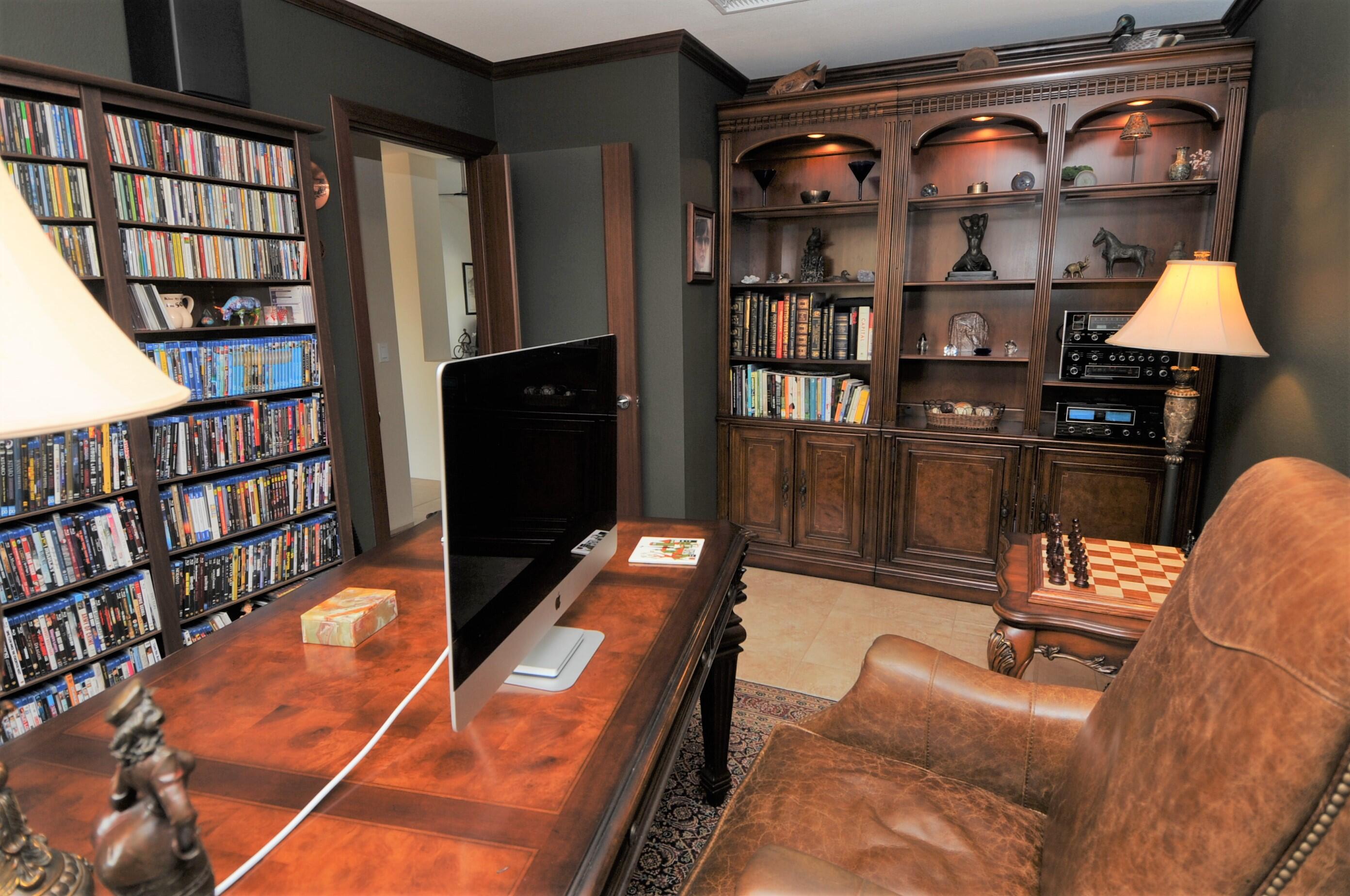 1490 East Racquet Club Road Palm Springs, CA 92262 - Photo 25 of 29 a living room with lots of furniture and a book shelf
