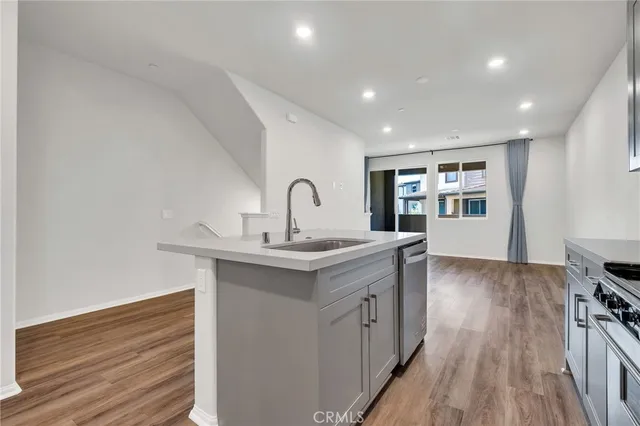 a kitchen with kitchen island white cabinets and stainless steel appliances