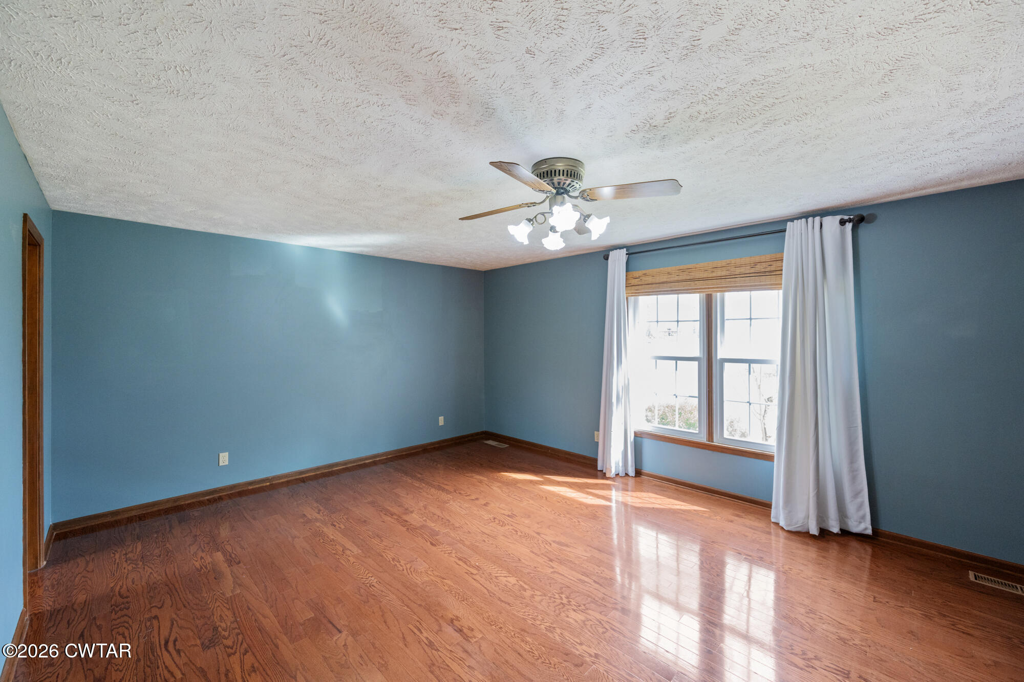 741 Independence Loop Lexington, TN 38351 - Photo 19 of 30 an empty room with chandelier fan and windows