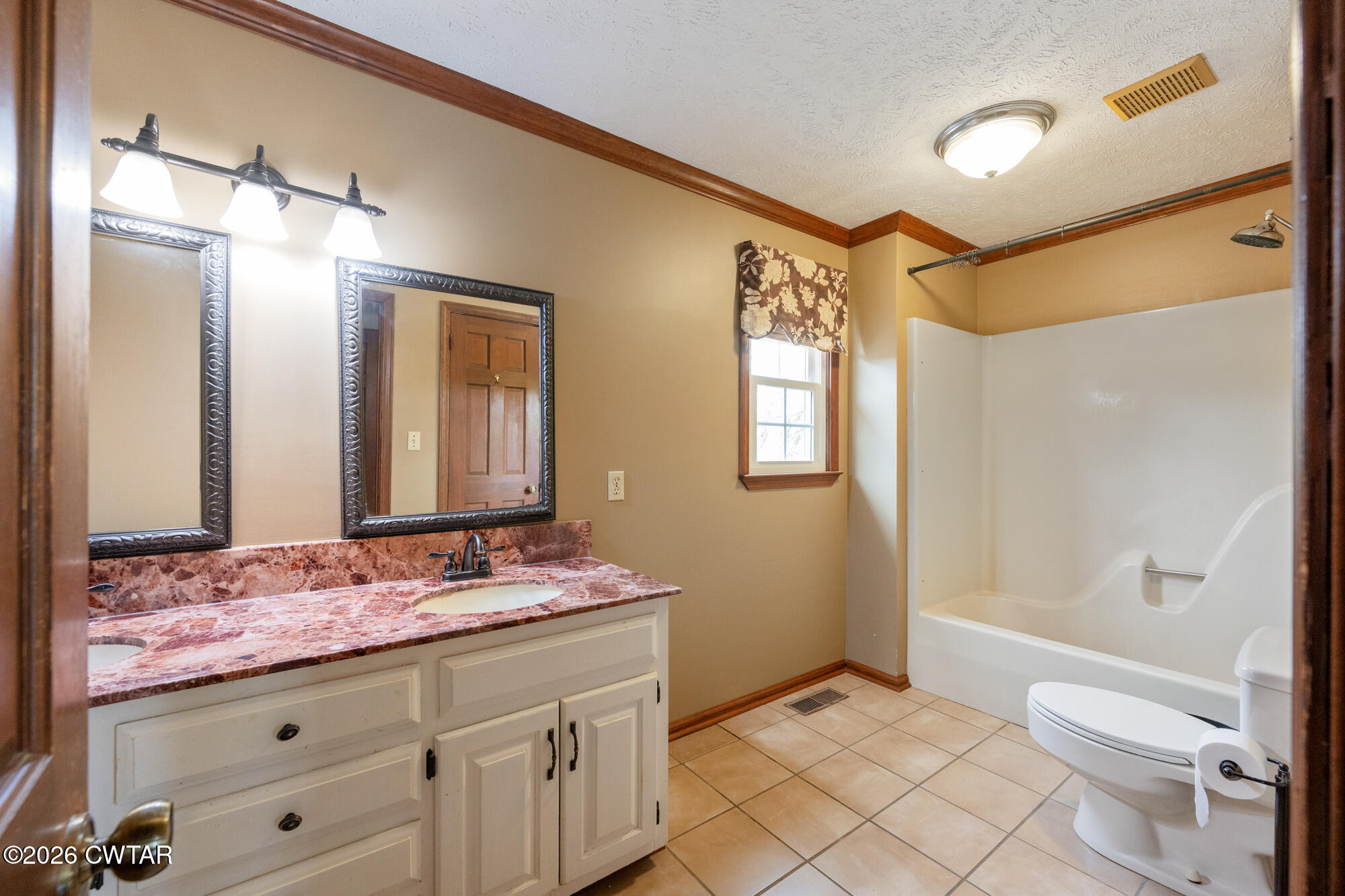 741 Independence Loop Lexington, TN 38351 - Photo 20 of 30 a bathroom with a granite countertop sink toilet and shower