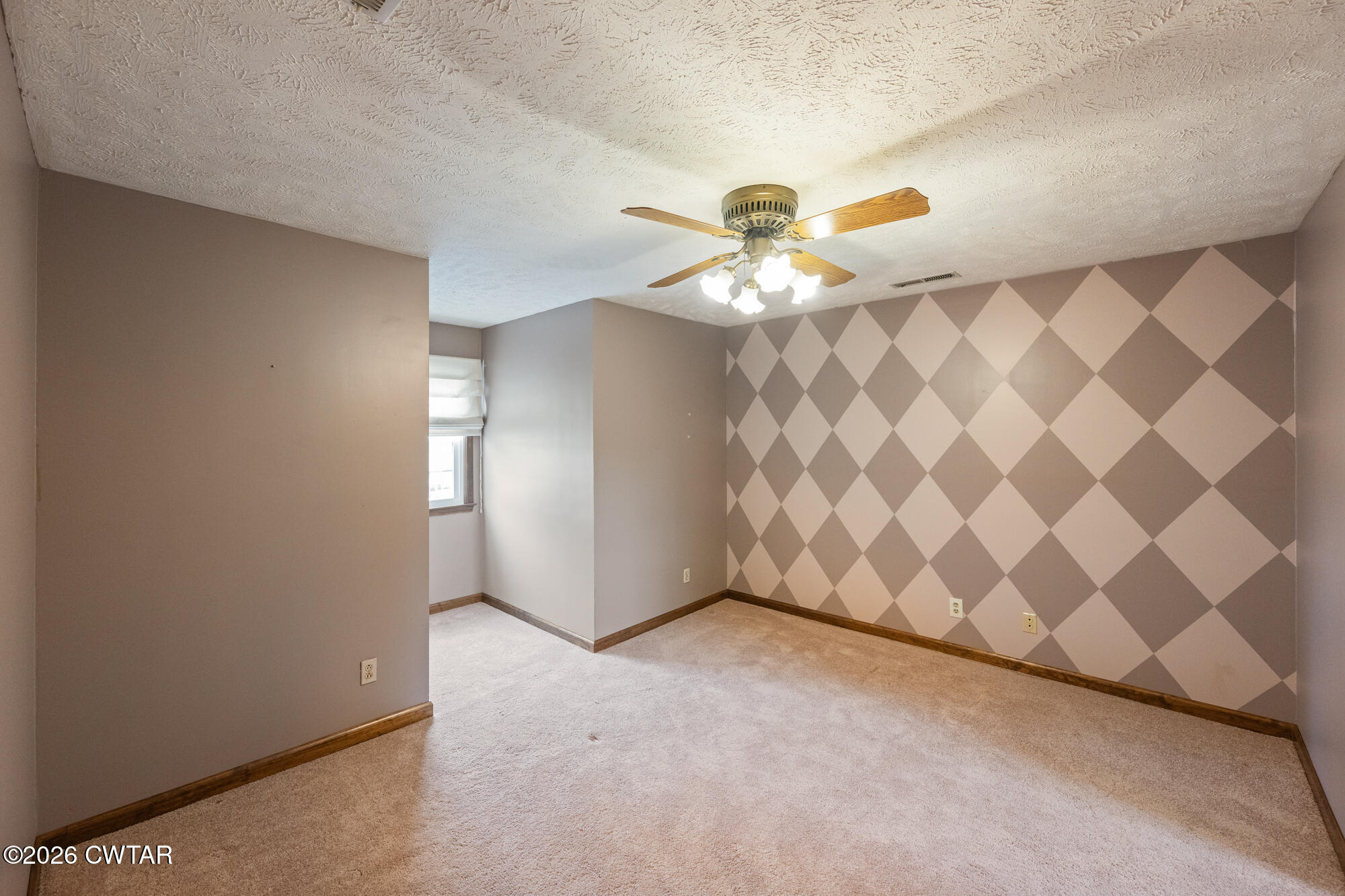 741 Independence Loop Lexington, TN 38351 - Photo 21 of 30 an empty room with windows and chandelier fan
