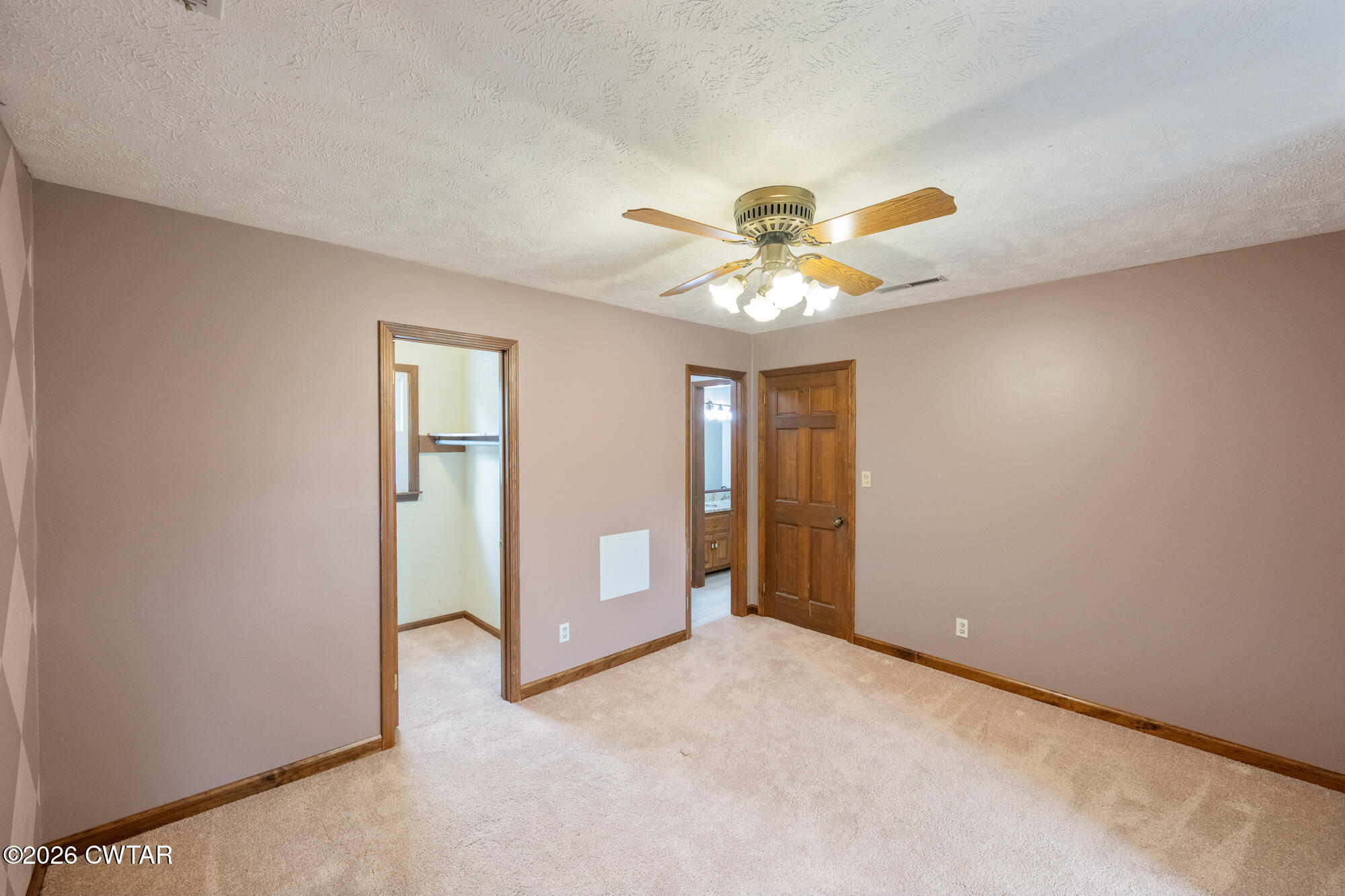 741 Independence Loop Lexington, TN 38351 - Photo 22 of 30 an empty room with chandelier fan and windows