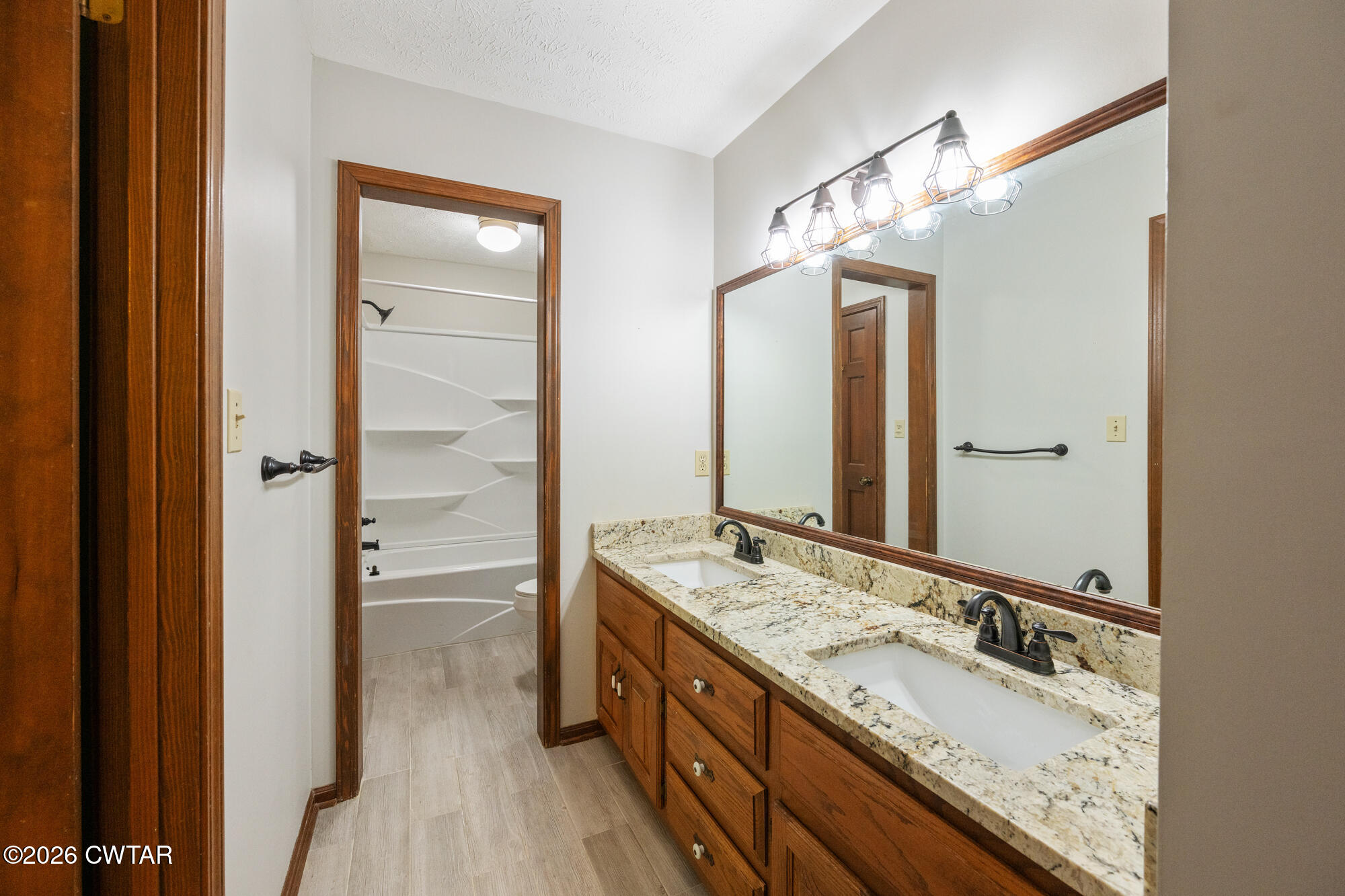 741 Independence Loop Lexington, TN 38351 - Photo 23 of 30 a bathroom with a double vanity sink mirror and double