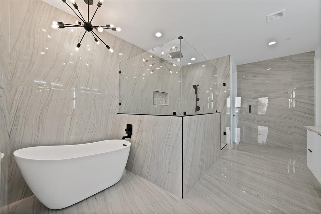443 Whispering Way Red Oak, TX 75154 - Photo 10 of 36 a bathroom with a bathtub and a shower