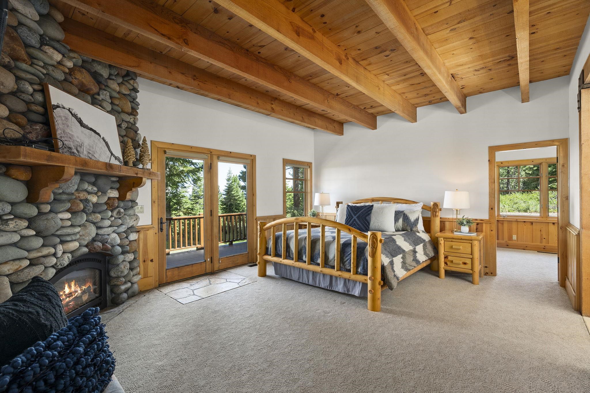 18168 La Mirada Road Truckee, CA 96161 - Photo 13 of 28 a spacious bedroom with a bed and a chandelier