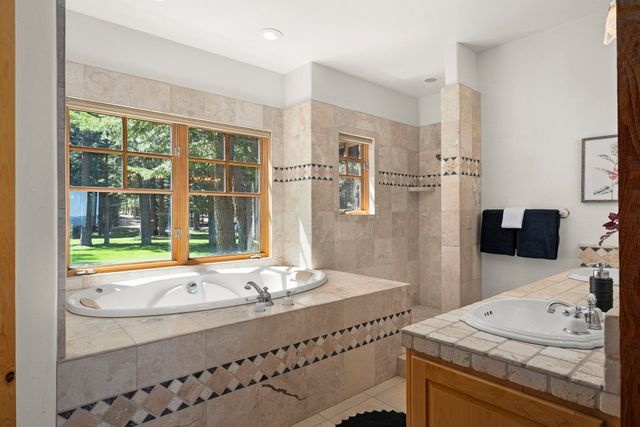 a bathroom with a granite countertop sink and a large mirror