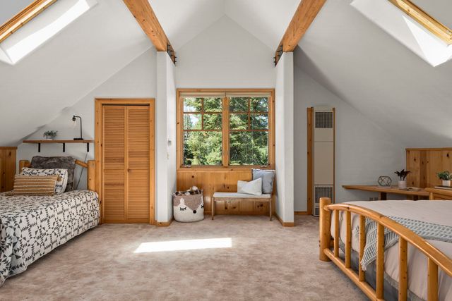 a spacious bedroom with furniture and a tub