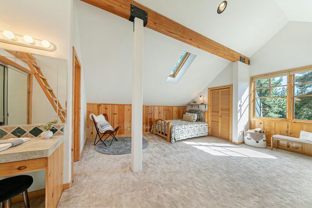 a view of a lush green field with a mountain in the background