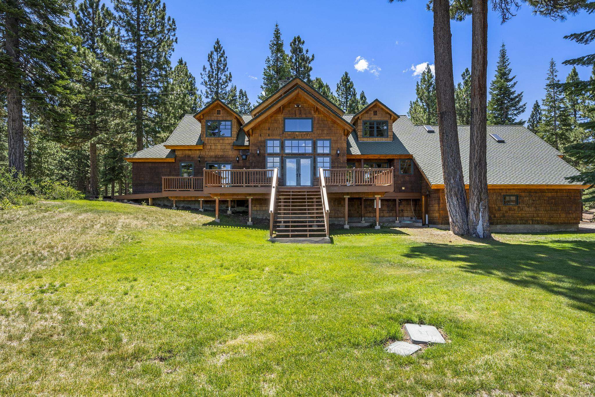 18168 La Mirada Road Truckee, CA 96161 - Photo 2 of 28 a view of a big house with a big yard and potted plants
