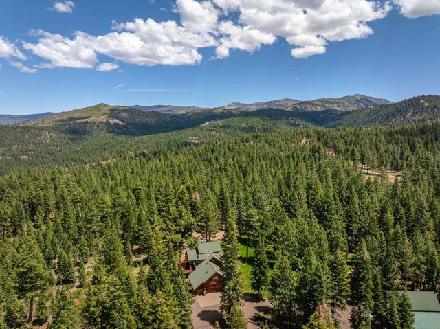 a view of a lush green hillside and a building