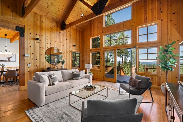 a living room with furniture and a floor to ceiling window