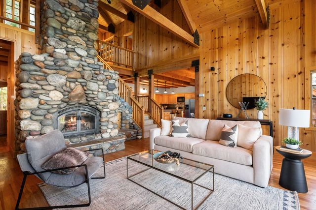 a living room with furniture a fireplace and walls