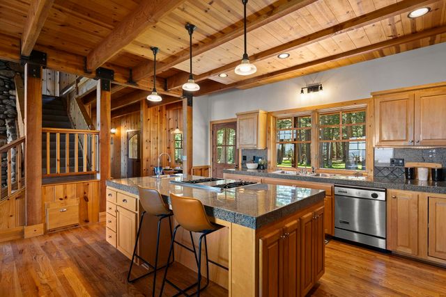 a kitchen with stainless steel appliances granite countertop a sink and cabinets