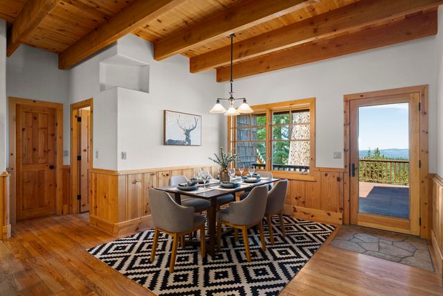 a dining room with furniture wooden floor and a chandelier