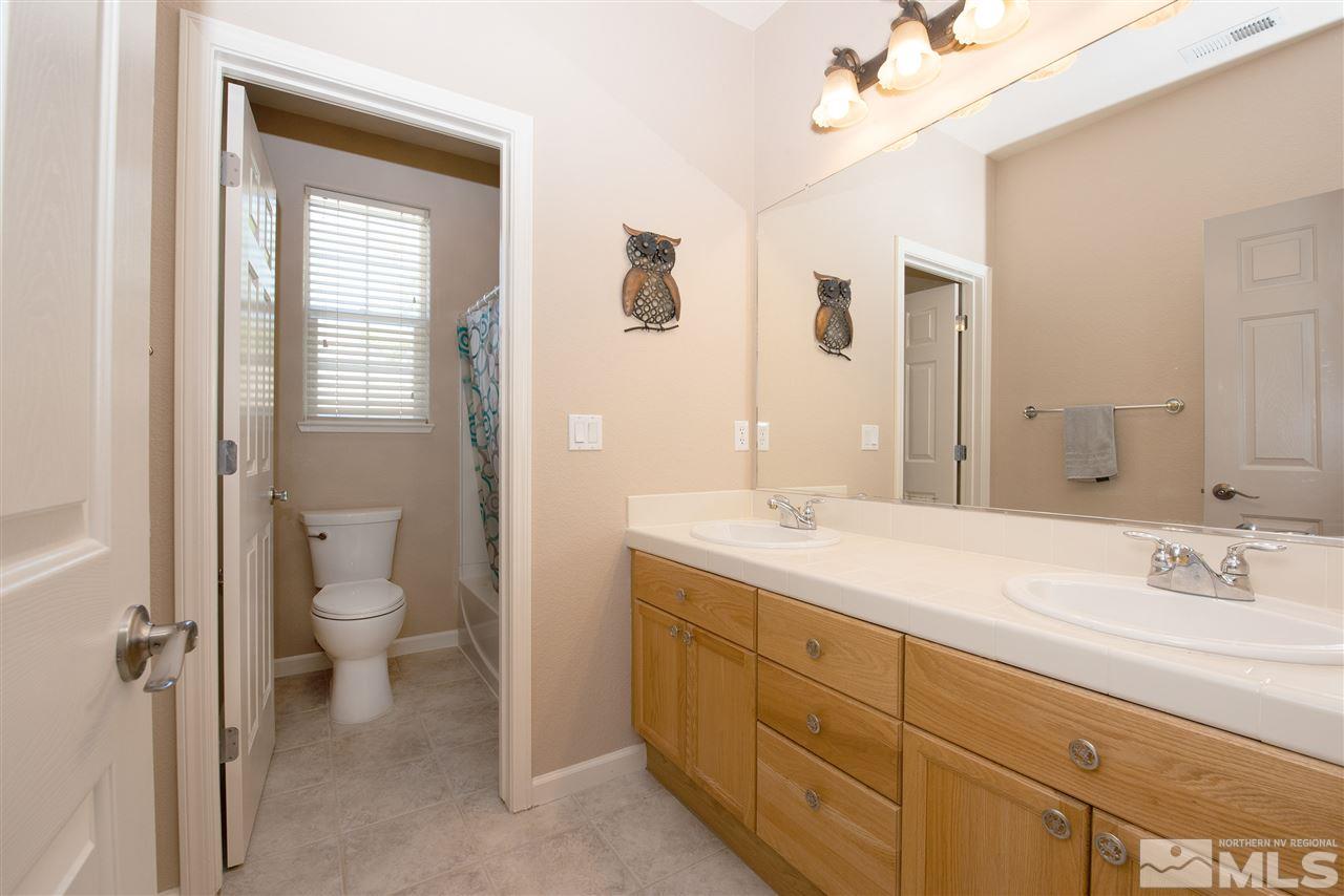 2480 Baton Drive Reno, NV 89521 - Photo 13 of 15 a spacious bathroom with a granite countertop sink toilet and shower