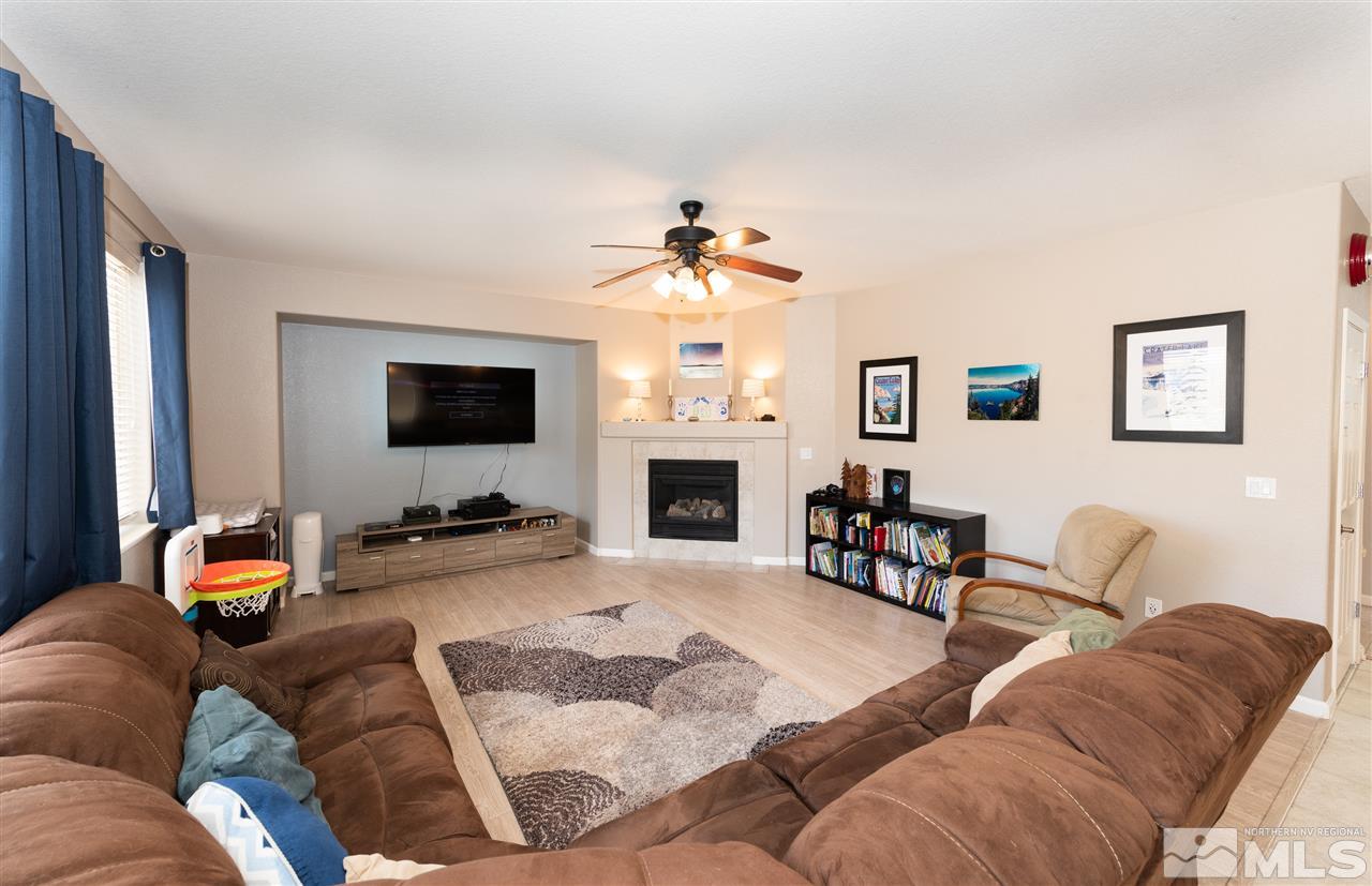 2480 Baton Drive Reno, NV 89521 - Photo 4 of 15 a living room with furniture a fireplace and a flat screen tv