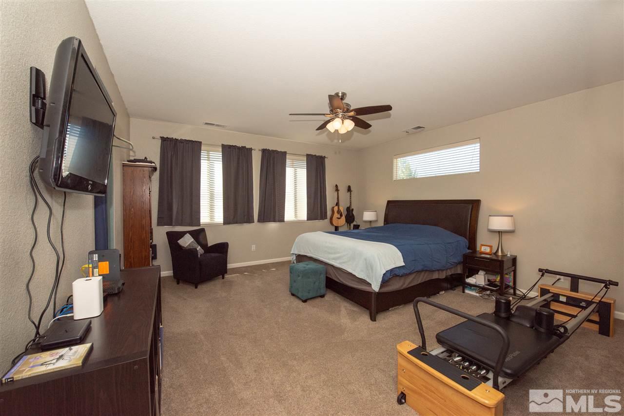 2480 Baton Drive Reno, NV 89521 - Photo 9 of 15 a spacious bedroom with a bed a couch and dresser