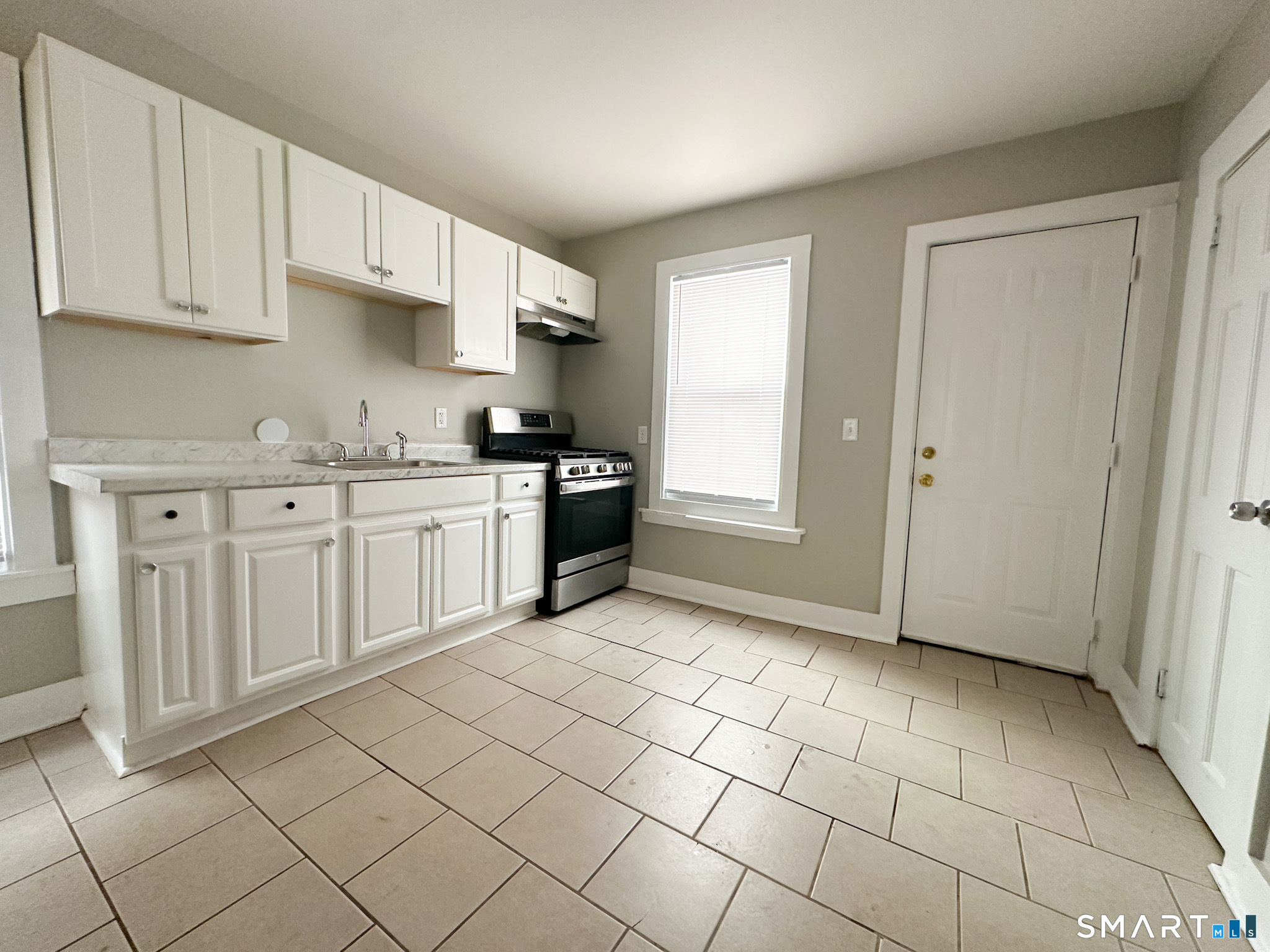 666 Orchard Street New Haven, CT 06511 - Photo 4 of 14 a kitchen with stainless steel appliances granite countertop a sink and cabinets