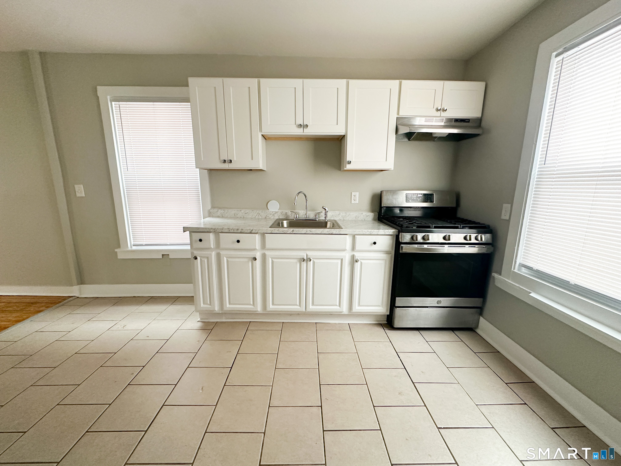 666 Orchard Street New Haven, CT 06511 - Photo 5 of 14 a kitchen with stainless steel appliances a stove a sink and a cabinets