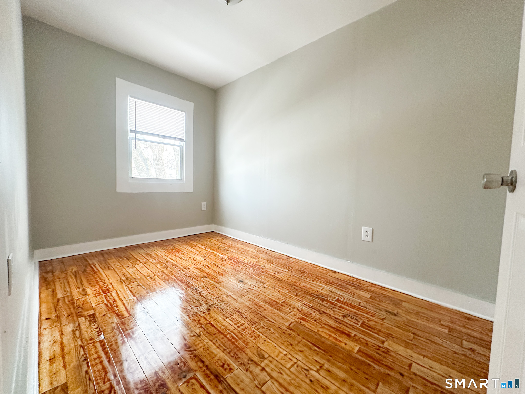 666 Orchard Street New Haven, CT 06511 - Photo 9 of 14 an empty room with wooden floor and windows