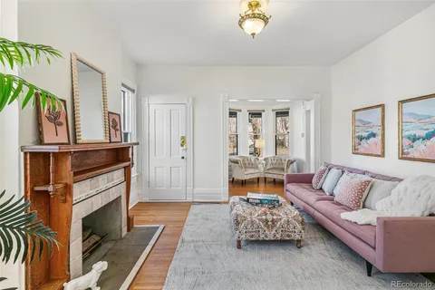 a living room with furniture fireplace and a window