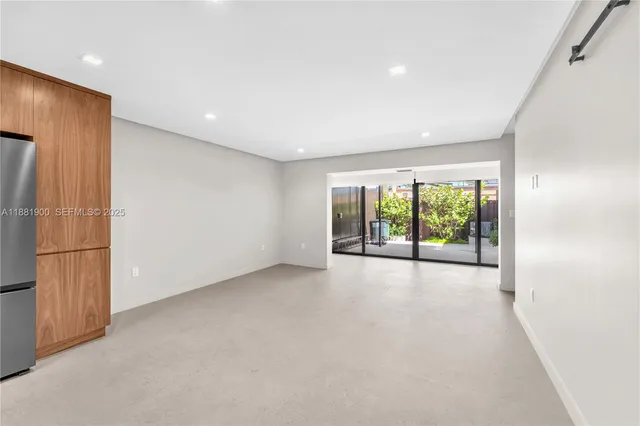 a view of a livingroom with an empty space and a window