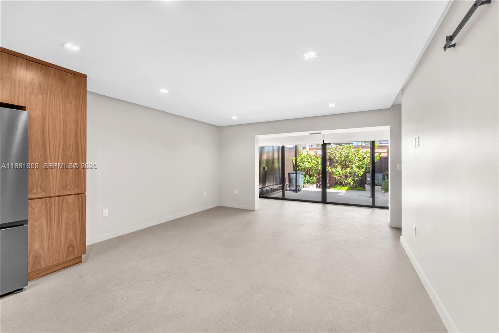 2211 Northeast 122nd Street, Unit 2211 North Miami, FL 33181 - Photo 14 of 34 a view of a livingroom with an empty space and a window
