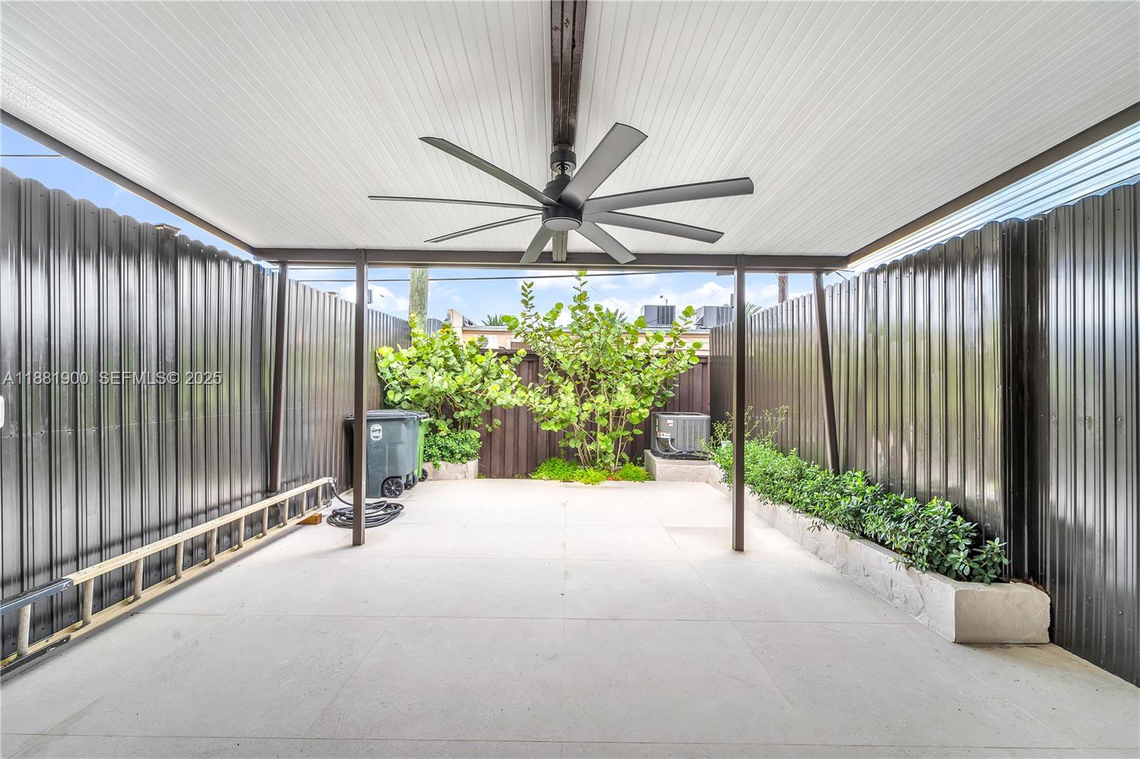 2211 Northeast 122nd Street, Unit 2211 North Miami, FL 33181 - Photo 16 of 34 a view of a porch with a garden