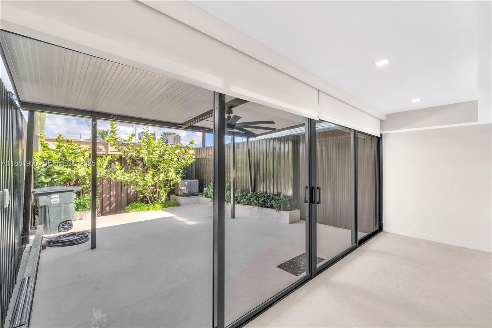 2211 Northeast 122nd Street, Unit 2211 North Miami, FL 33181 - Photo 19 of 34 a view of a hallway with a glass door