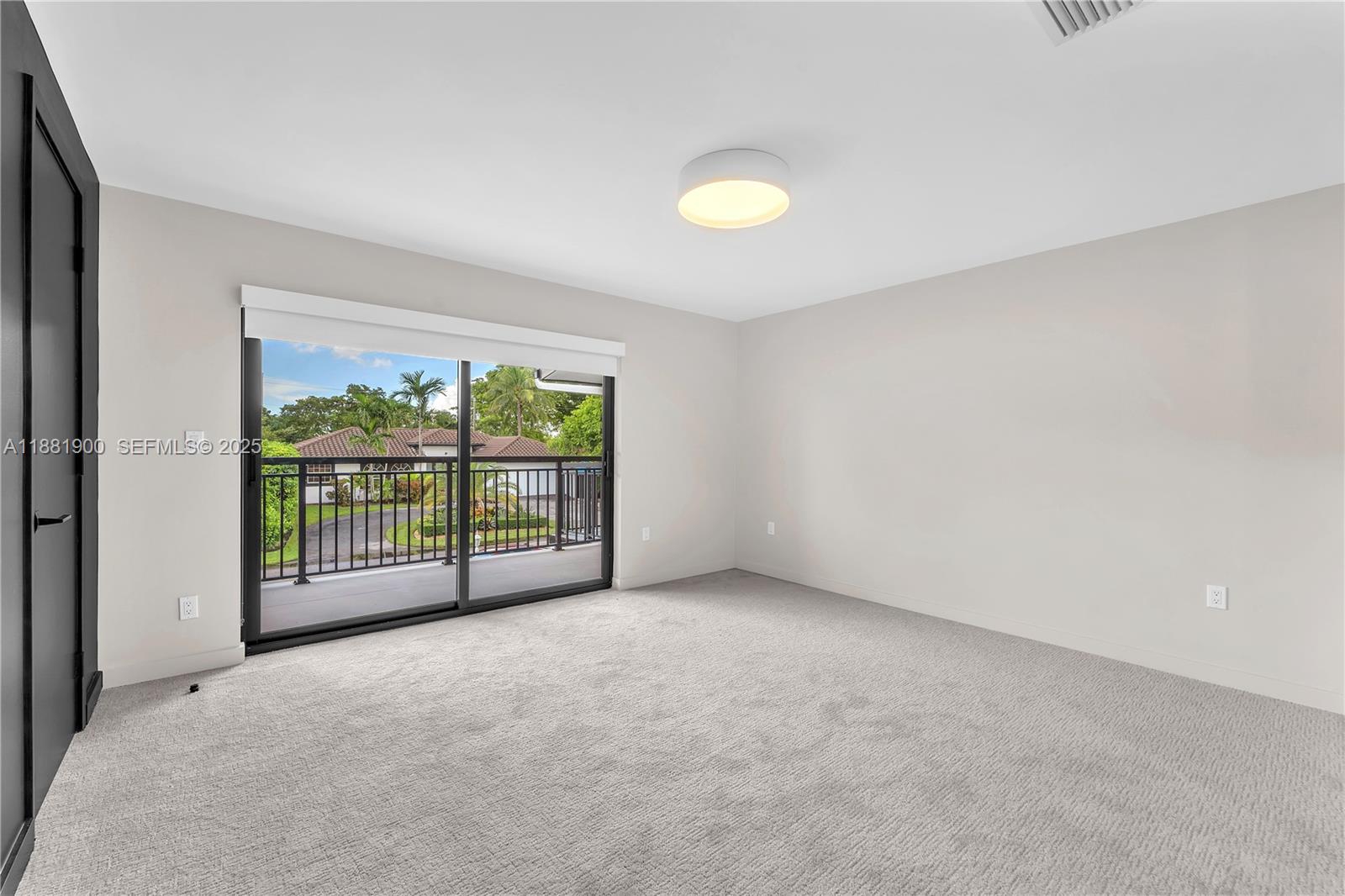 2211 Northeast 122nd Street, Unit 2211 North Miami, FL 33181 - Photo 21 of 34 a view of an empty room with a balcony