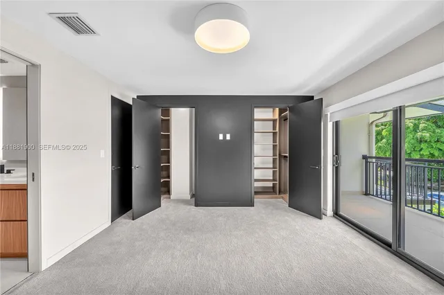 an empty room with windows and closet