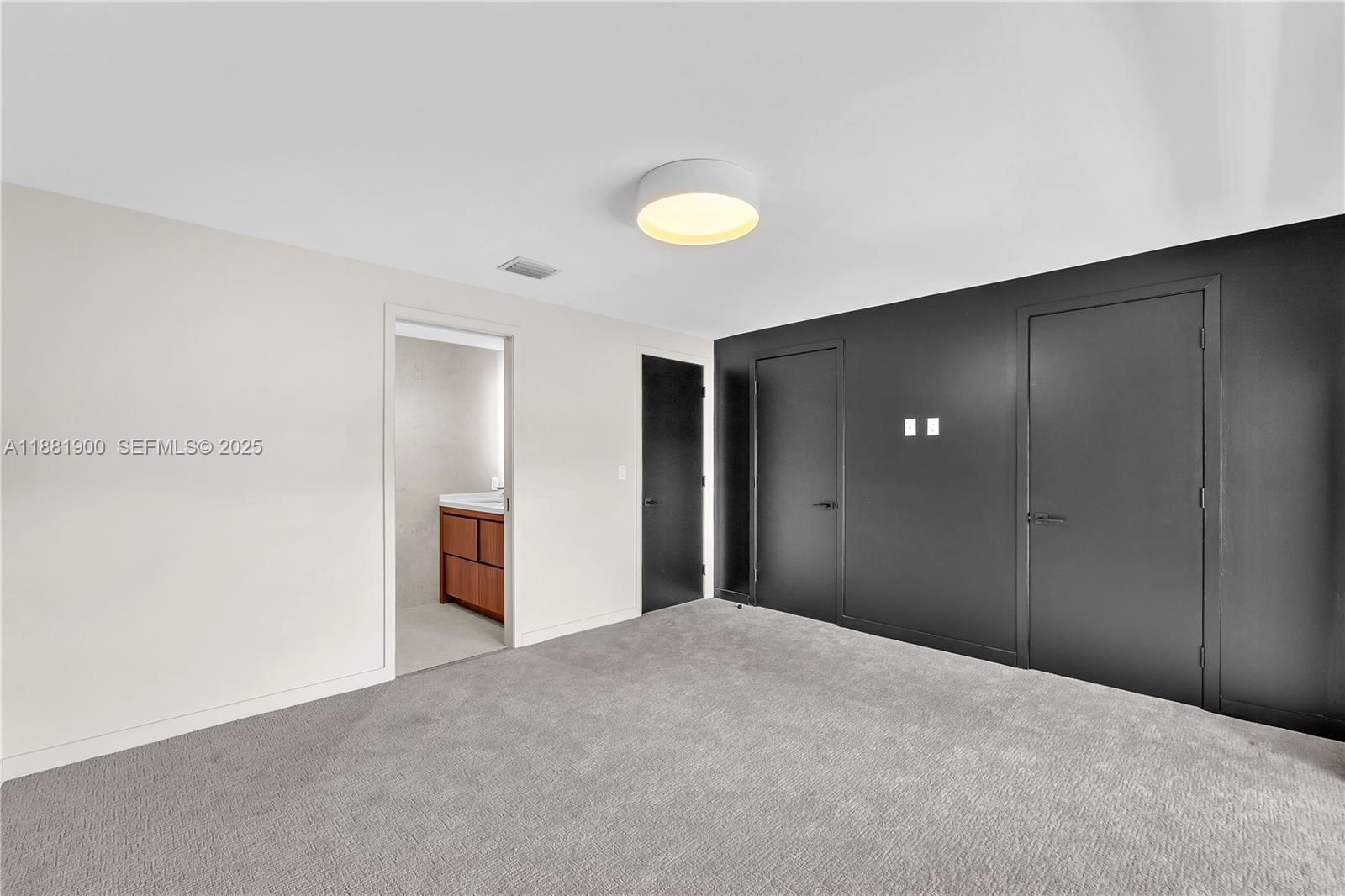 2211 Northeast 122nd Street, Unit 2211 North Miami, FL 33181 - Photo 25 of 34 a view of a room with a chandelier fan and closet