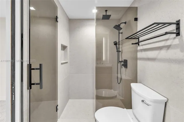 a bathroom with a toilet and a shower