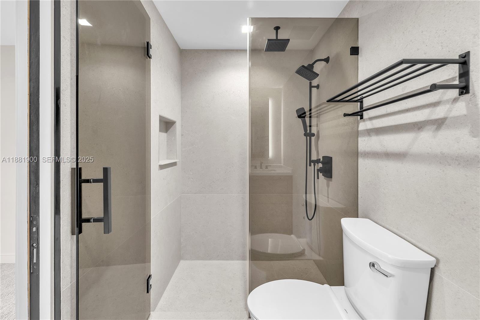 2211 Northeast 122nd Street, Unit 2211 North Miami, FL 33181 - Photo 28 of 34 a bathroom with a toilet and a shower