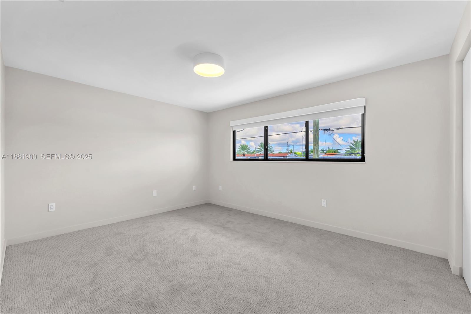 2211 Northeast 122nd Street, Unit 2211 North Miami, FL 33181 - Photo 30 of 34 an empty room with windows