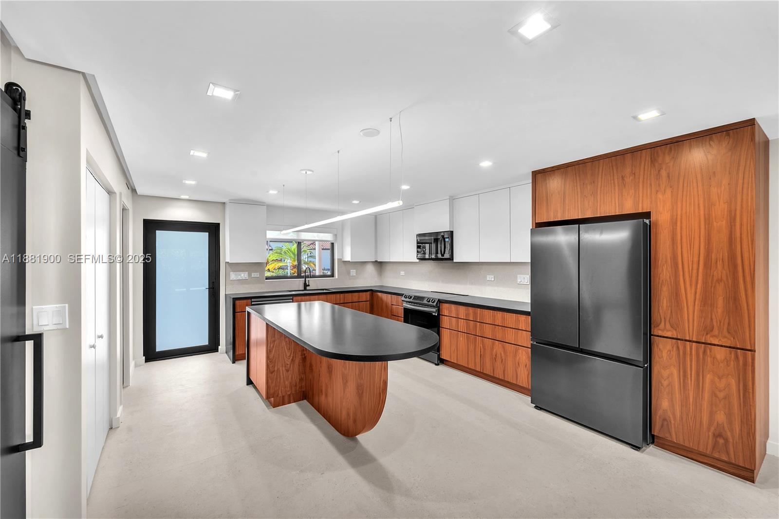 2211 Northeast 122nd Street, Unit 2211 North Miami, FL 33181 - Photo 5 of 34 a kitchen with stainless steel appliances granite countertop a refrigerator and a sink