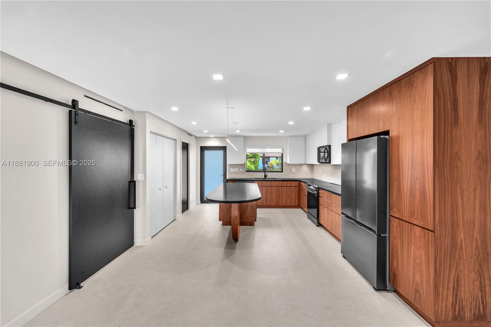 2211 Northeast 122nd Street, Unit 2211 North Miami, FL 33181 - Photo 8 of 34 a large kitchen with stainless steel appliances a refrigerator and a sink