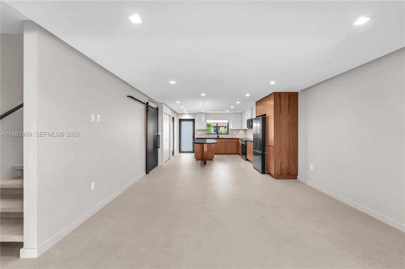 2211 Northeast 122nd Street, Unit 2211 North Miami, FL 33181 - Photo 10 of 34 a view of a livingroom with a kitchen