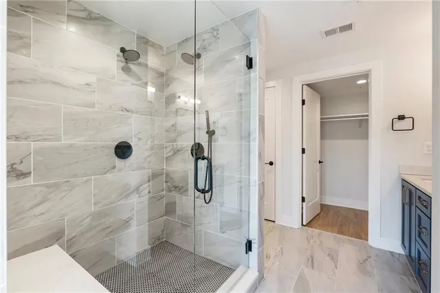 a bathroom with a bathtub and shower