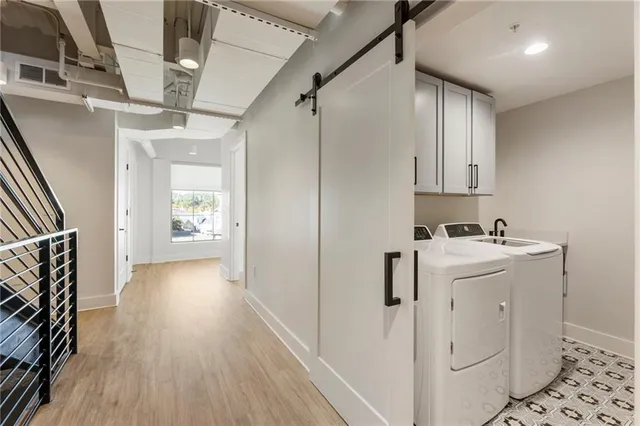 a large kitchen with stainless steel appliances wooden floor and a counter top space