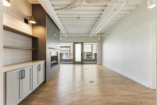 a view of an empty room with a fireplace and a window