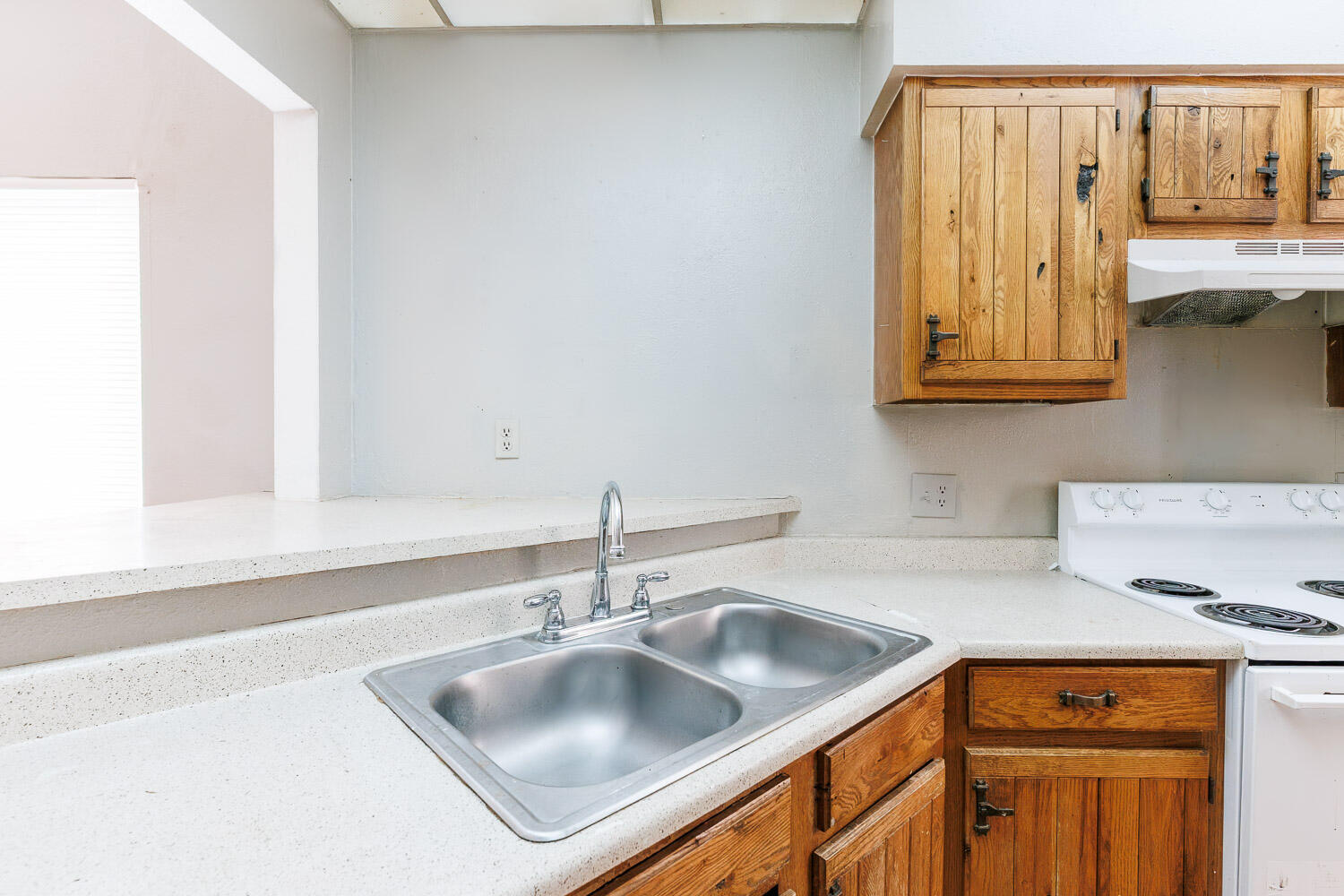 7405 Avenue X, Unit 103 Lubbock, TX 79423 - Photo 13 of 33 a kitchen with stainless steel appliances granite countertop a sink and a wooden cabinets