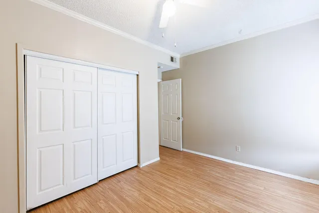 a view of an empty room with wooden floor