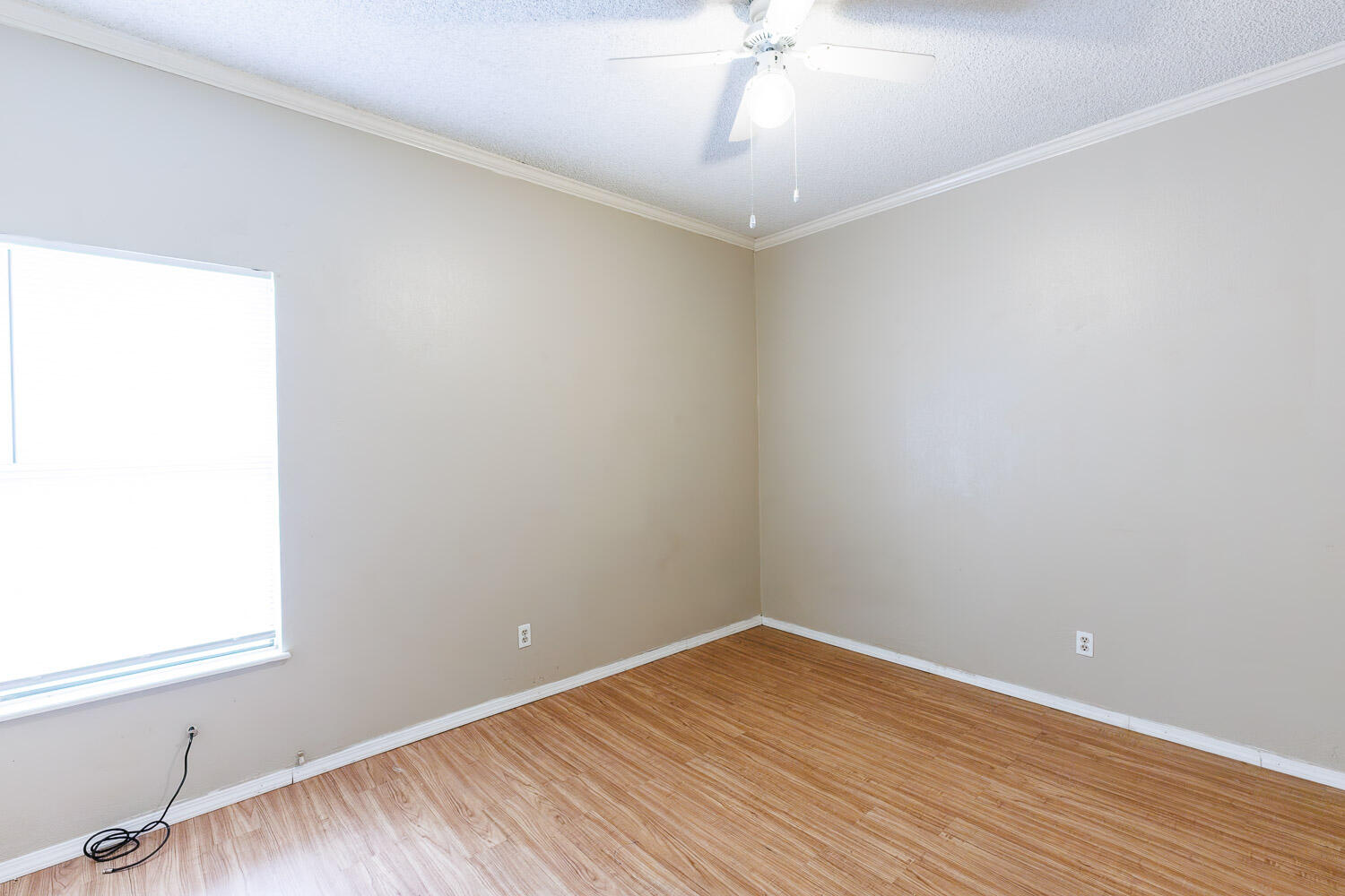 7405 Avenue X, Unit 103 Lubbock, TX 79423 - Photo 22 of 33 a view of a room with wooden floor and fan