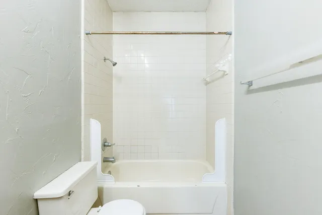 a bathroom with a bathtub and a shower