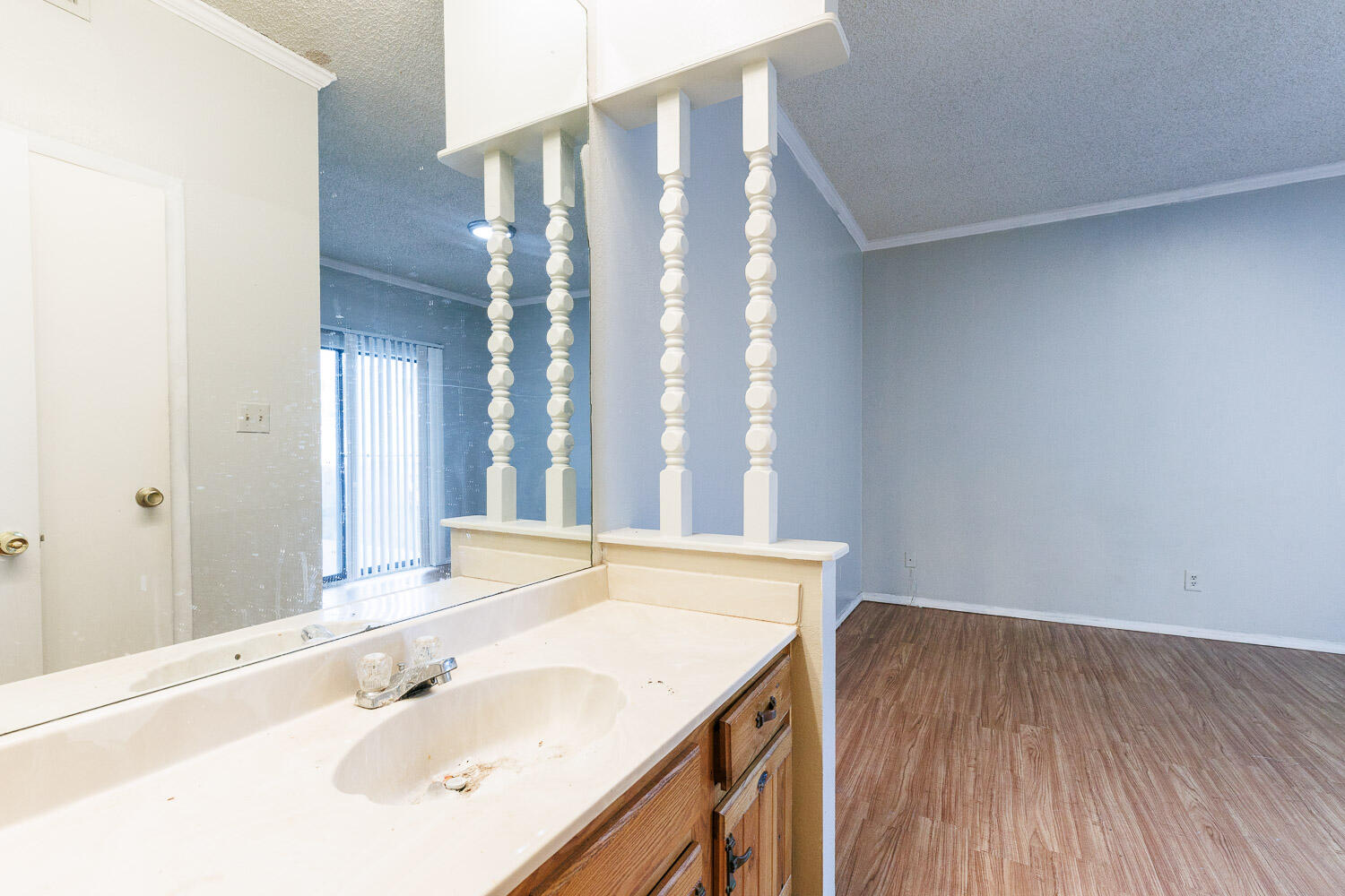 7405 Avenue X, Unit 103 Lubbock, TX 79423 - Photo 30 of 33 a bathroom with a sink and a large mirror