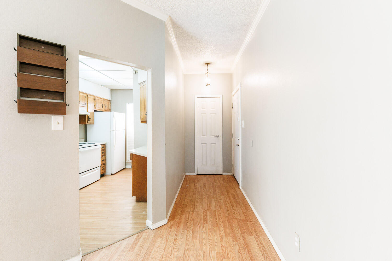 7405 Avenue X, Unit 103 Lubbock, TX 79423 - Photo 4 of 33 a view of a hallway with wooden floor and staircase