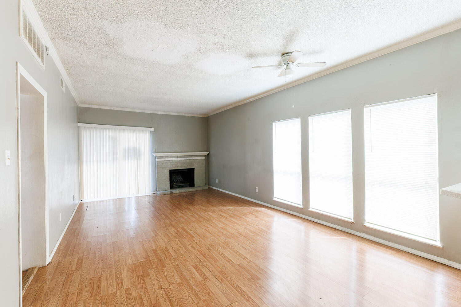 7405 Avenue X, Unit 103 Lubbock, TX 79423 - Photo 5 of 33 wooden floor in an empty room with a window
