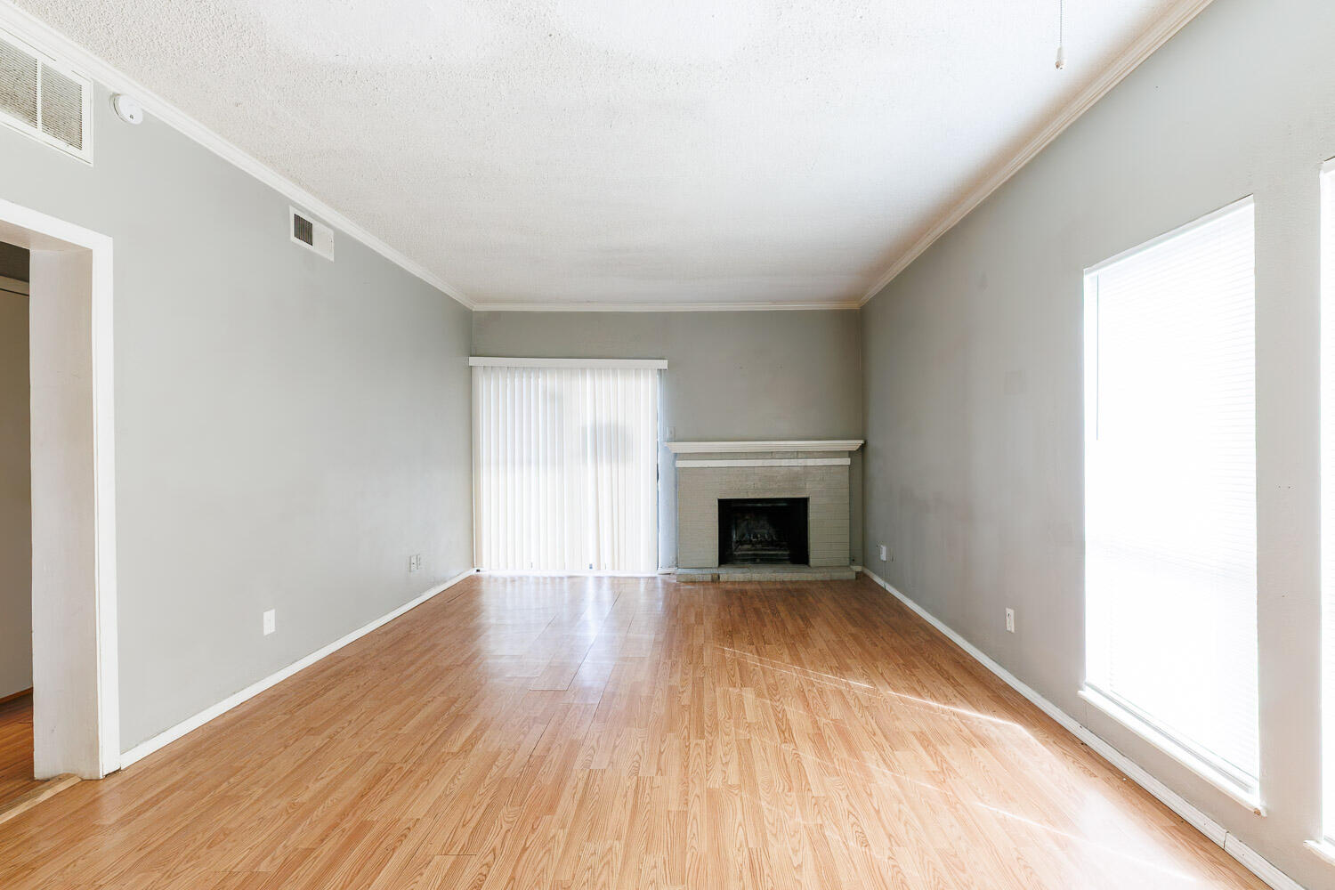 7405 Avenue X, Unit 103 Lubbock, TX 79423 - Photo 6 of 33 a view of an empty room with wooden floor with windows